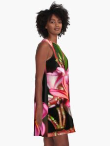 A model wearing a Plumeria Flowers Dress. Bright, and colorful side view.